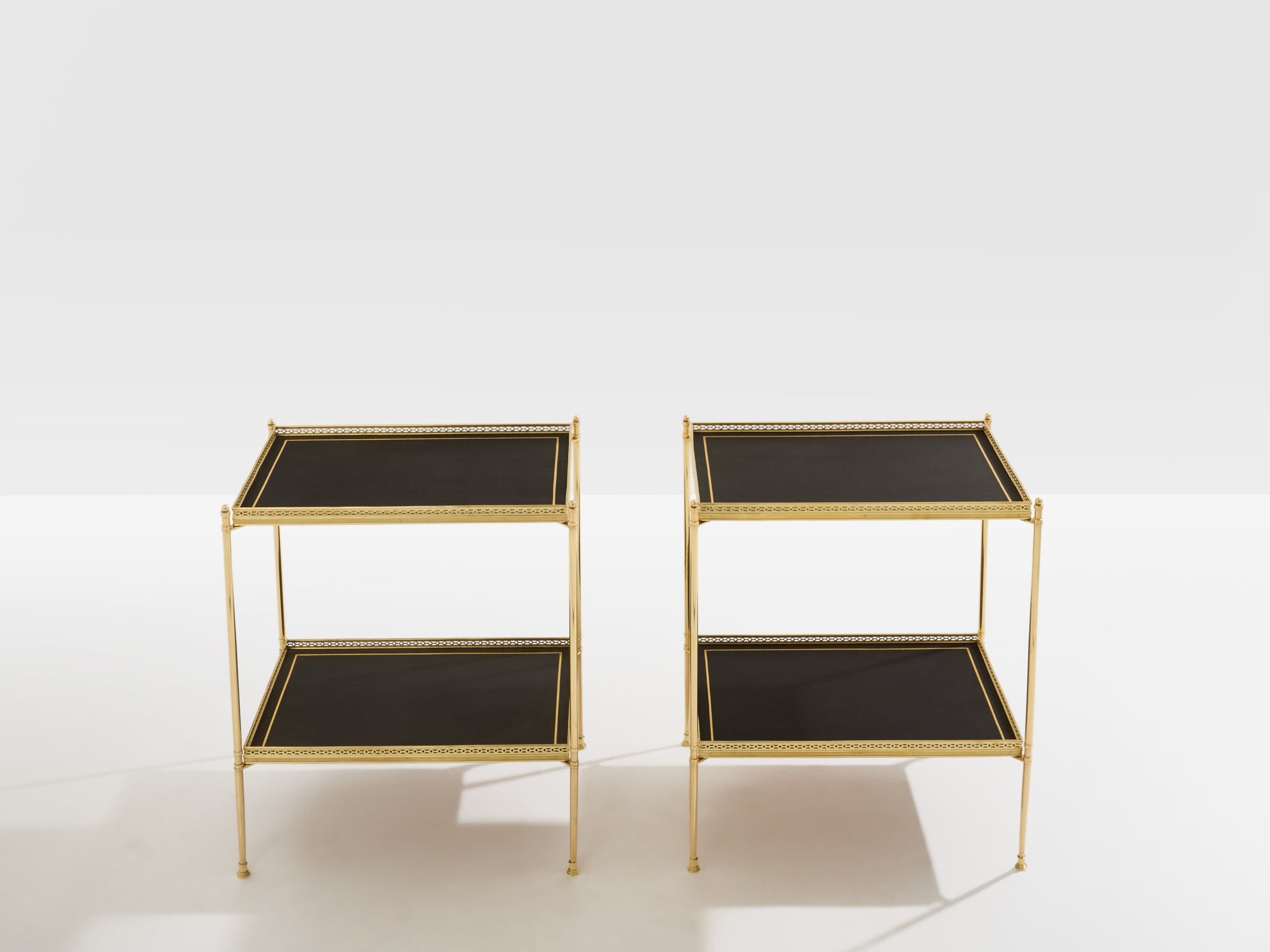 Maison Jansen pair of two-tier side tables brass black leather 1960s