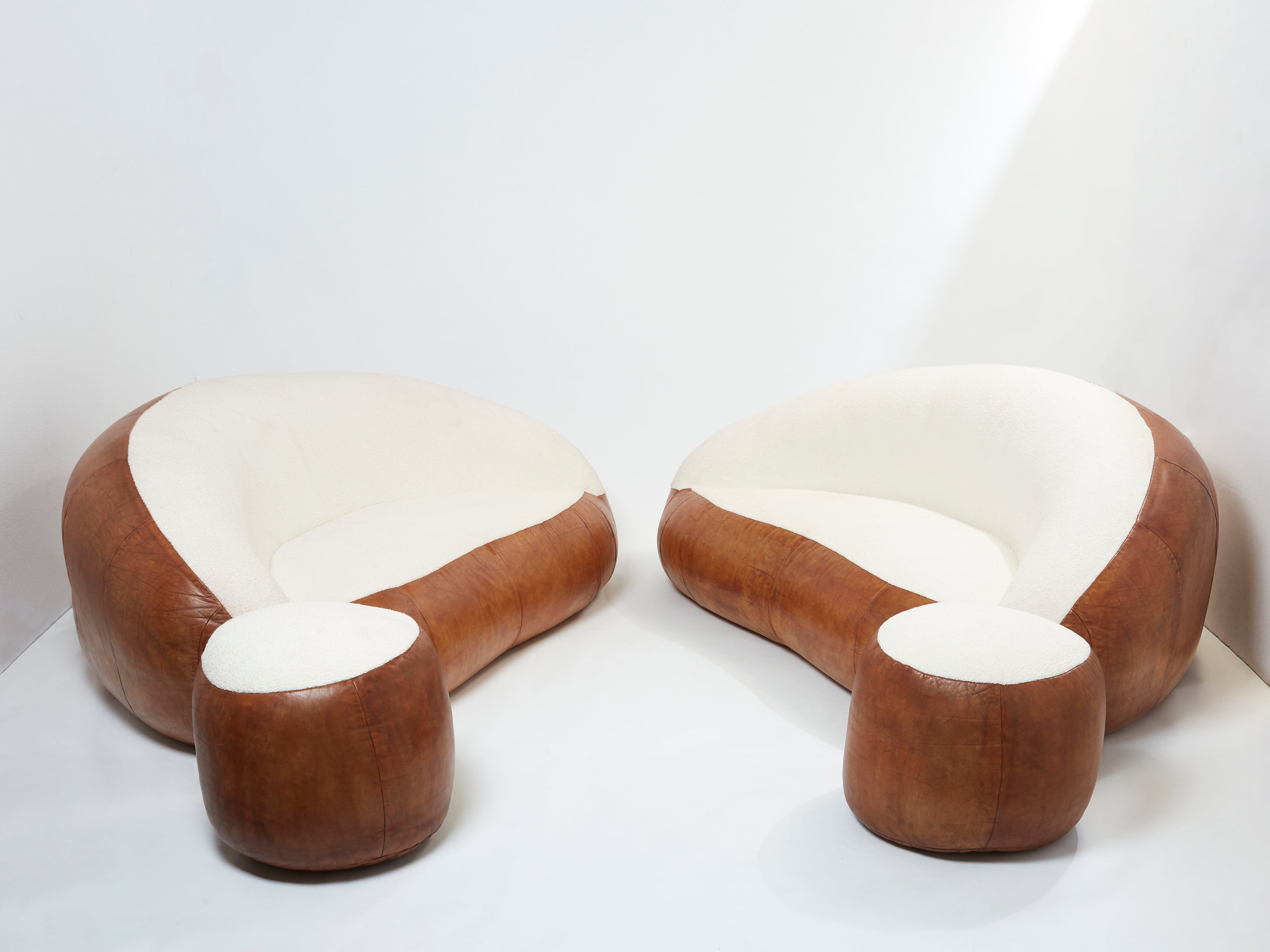 Set of two croissant sofas by Raphael Raffel leather and bouclé 1970s
