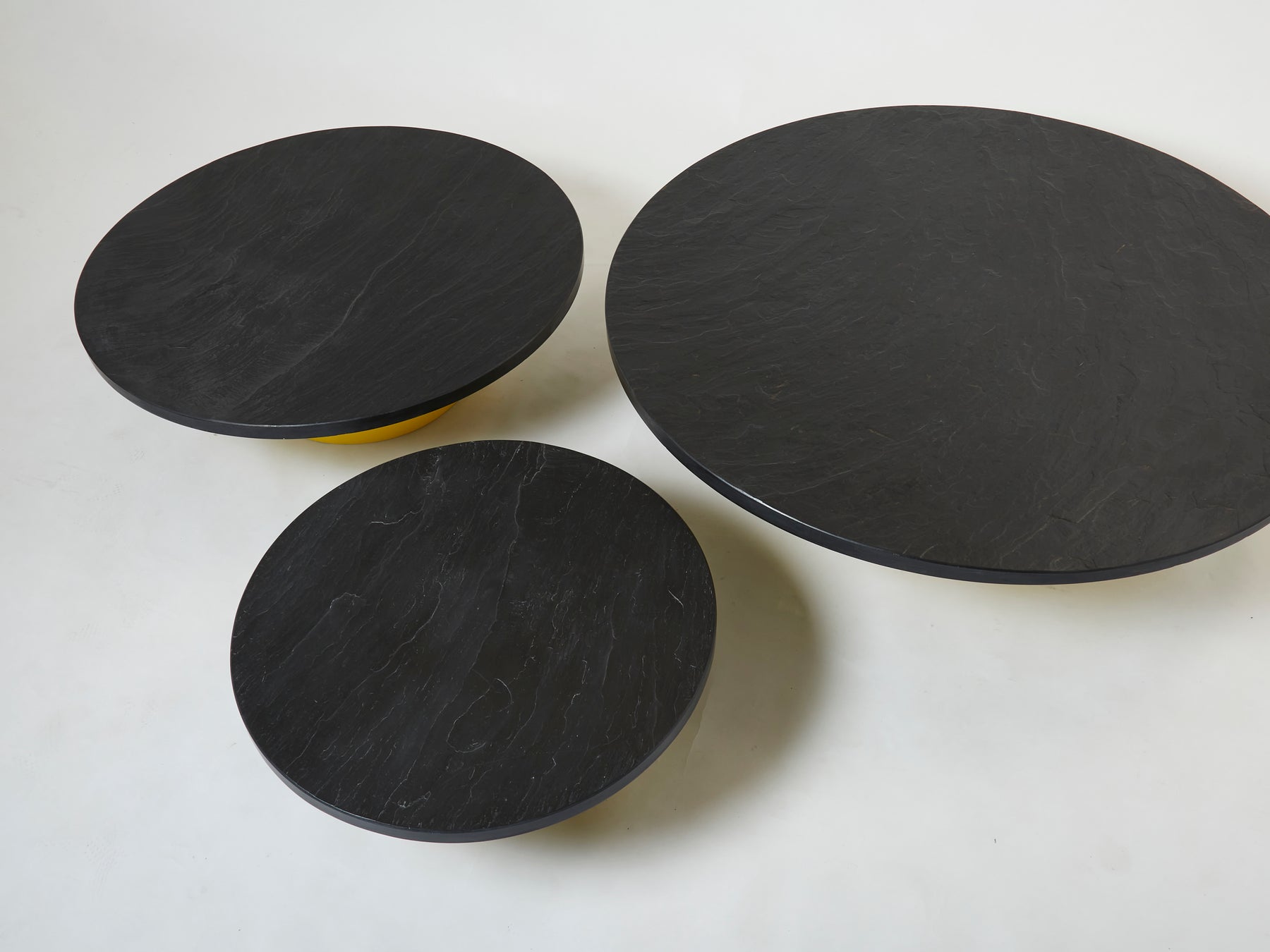Set of three large round coffee tables yellow lacquer slate tops 1970s
